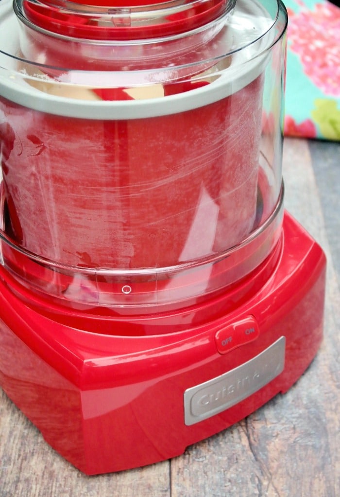 Red ice cream maker churning homemade ice cream.