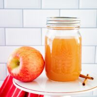Homemade apple pie moonshine in a mason jar ready to be enjoyed.
