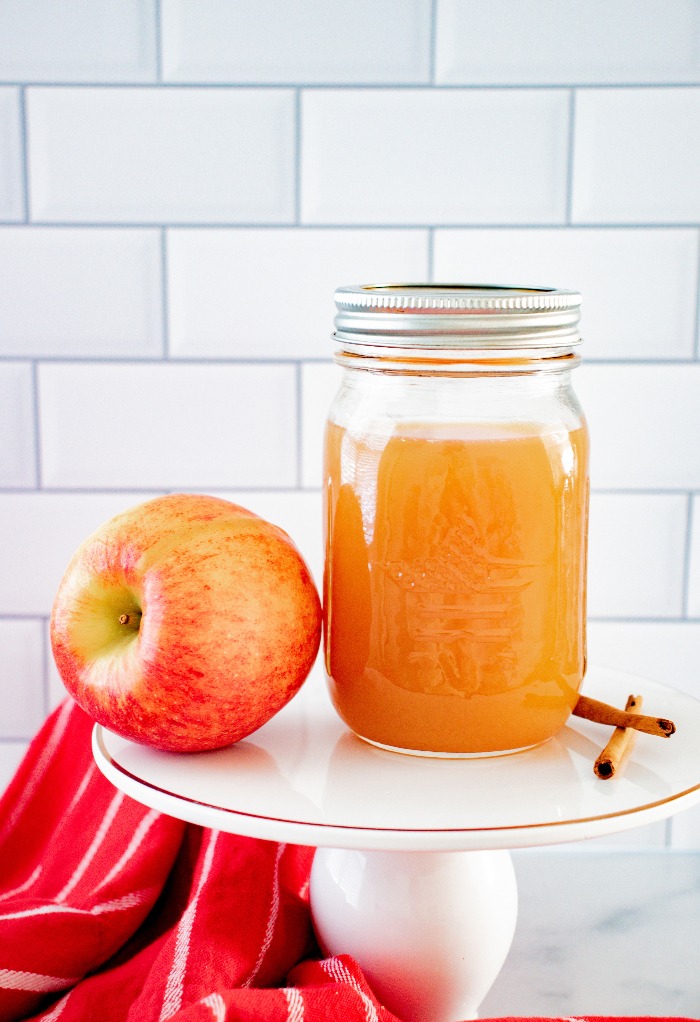 Homemade apple pie moonshine in a mason jar ready to be enjoyed.