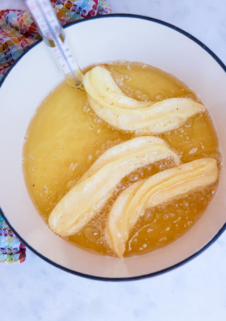 Frying churros in a round Dutch oven pan. 