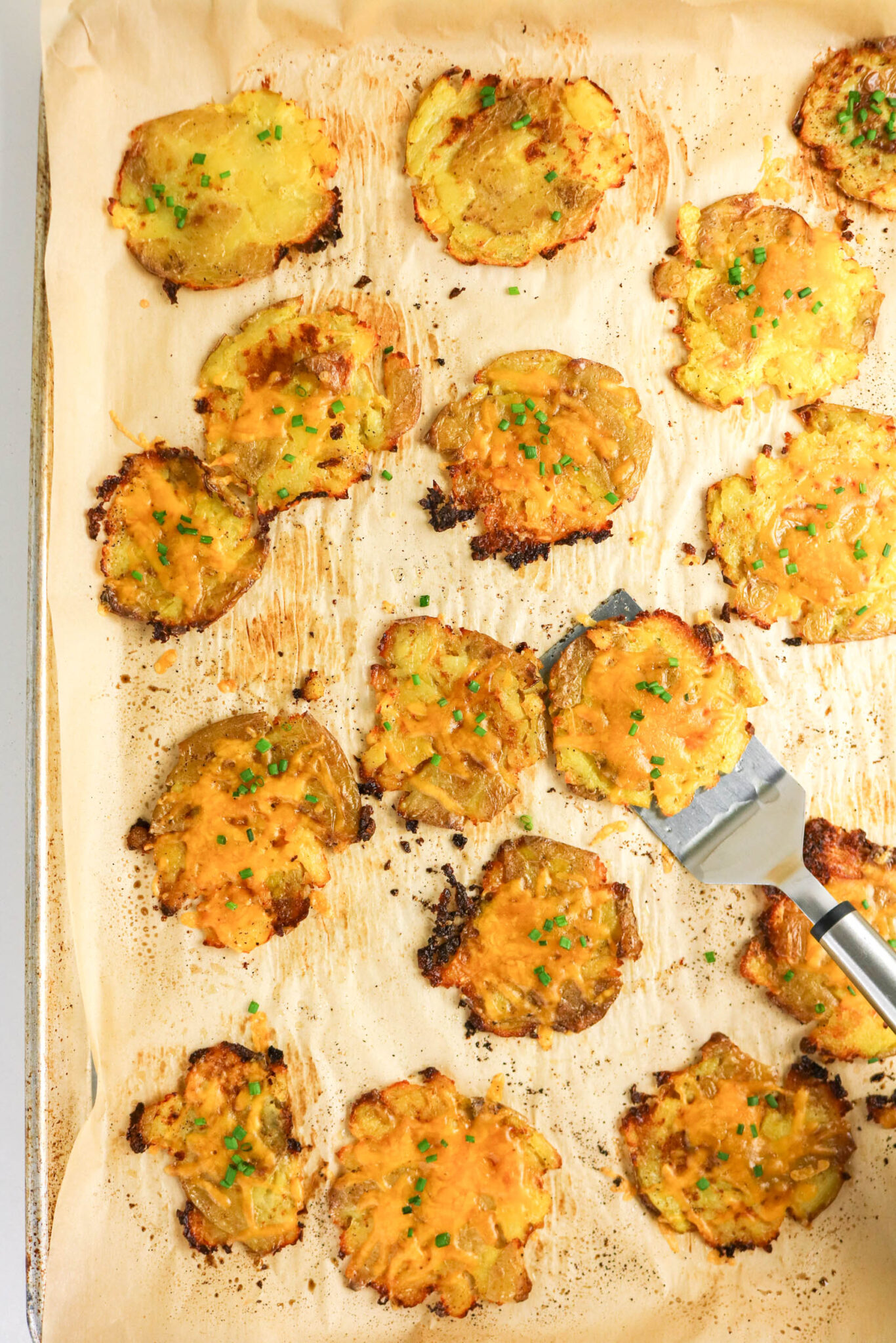 smashed potatoes topped with cheese and chives.
