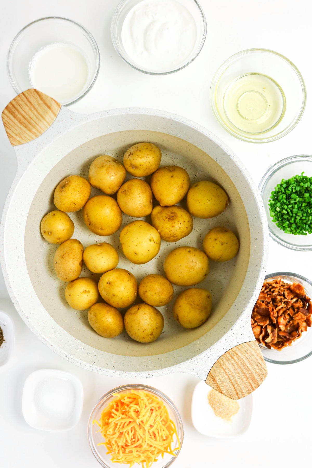 Baby potatoes in a large dutch pan filled with water.
