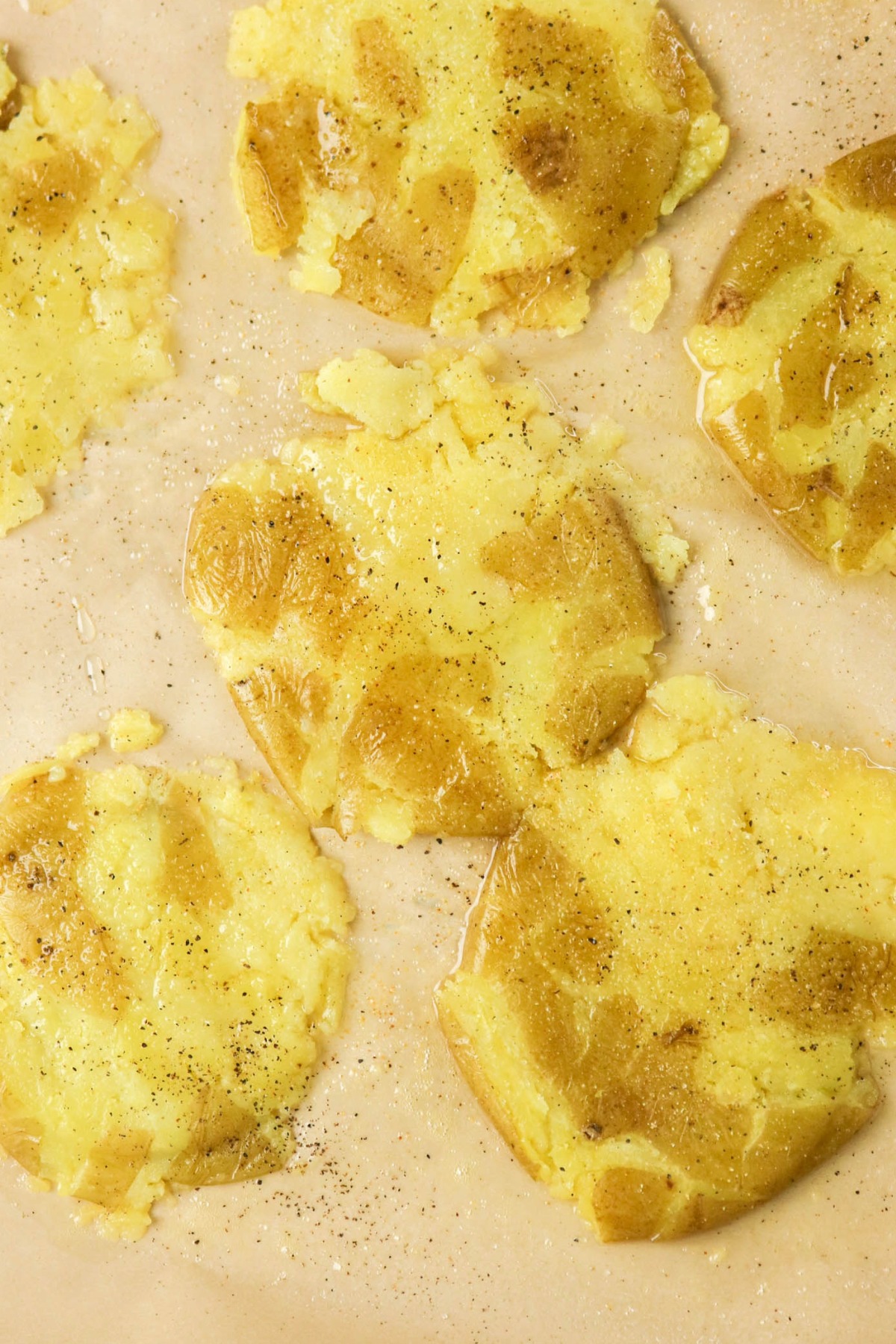 smashed potatoes topped with salt and pepper before roasting.