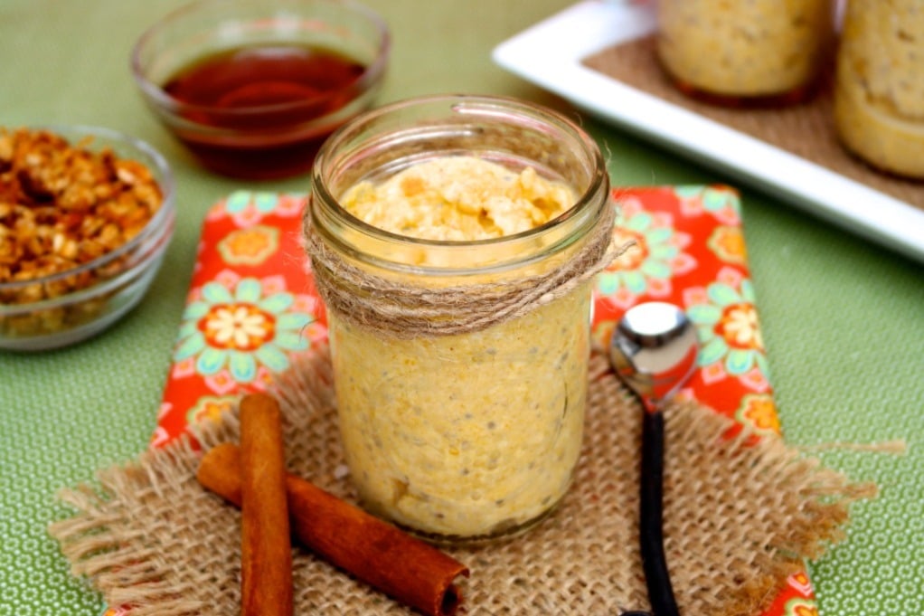 Oatmeal in a mason jar with cinnamon sticks on the side. 