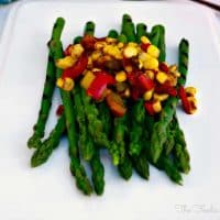 Asparagus with Sautéed Veggies on a white serving plate