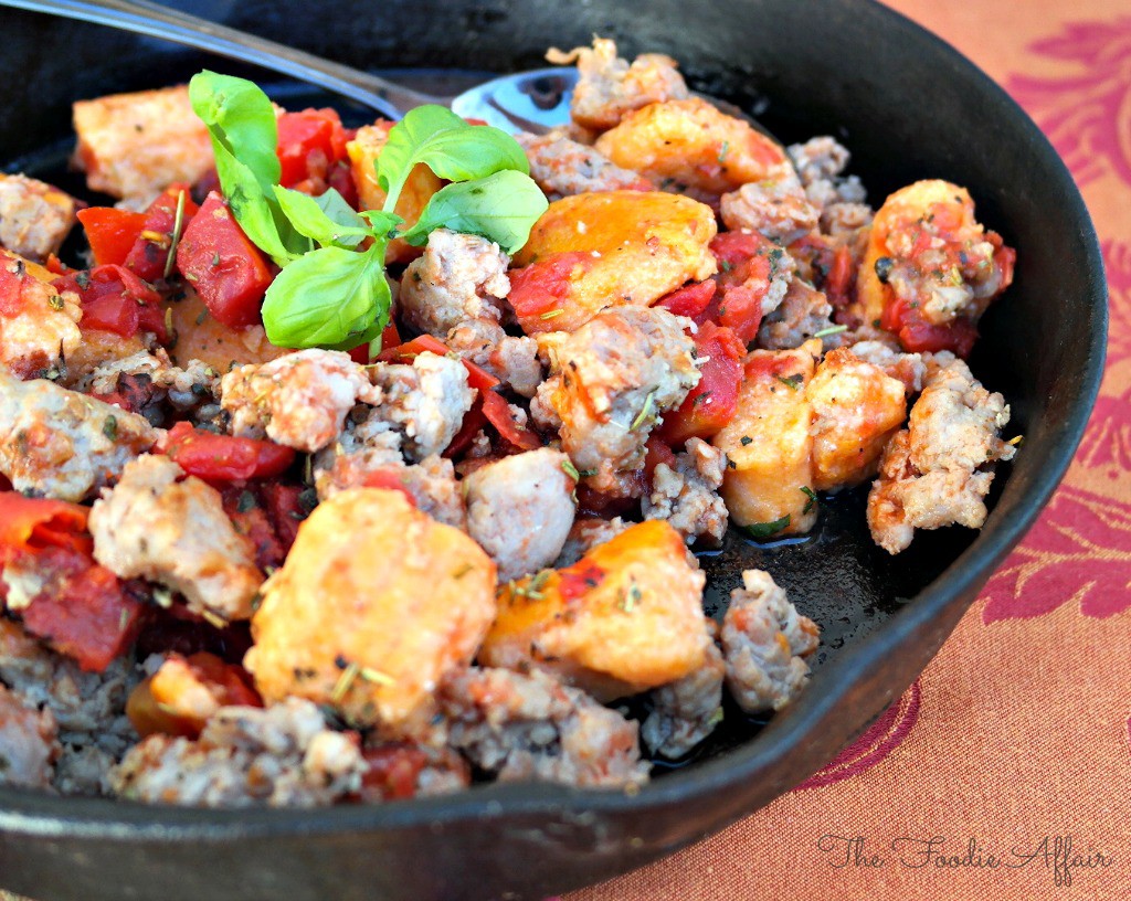 Gnocchi with Sausage and Tomatoes in an iron skillet.