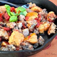 Gnocchi with Sausage and Tomatoes in an iron skillet.
