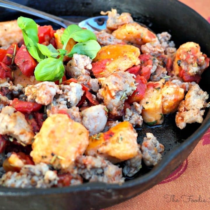Gnocchi with Sausage and Tomatoes in an iron skillet