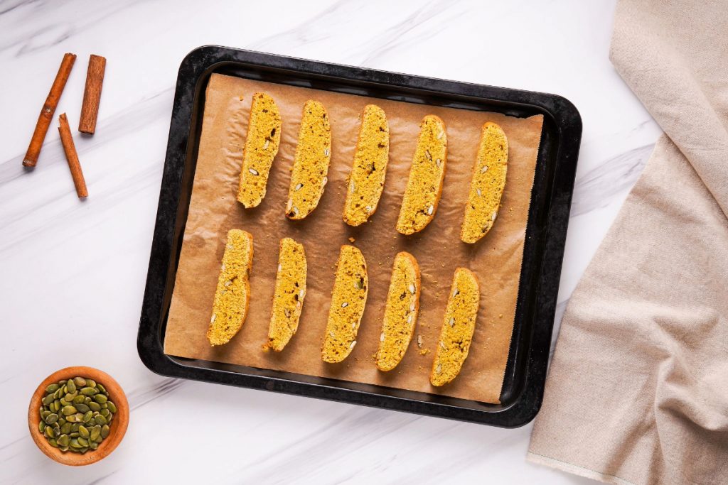 Sliced biscotti on a baking sheet.