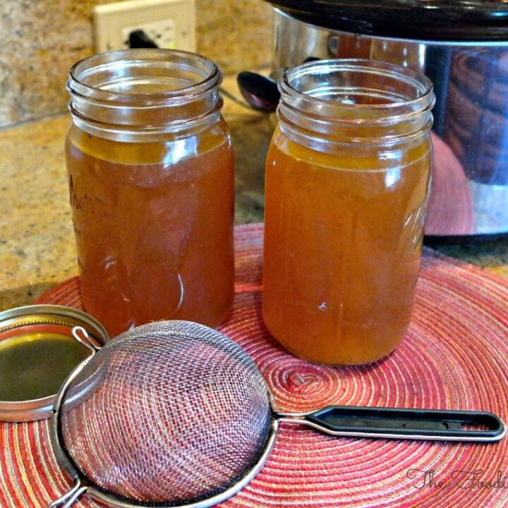Two mason jars filled with turkey broth made in a slow cooker