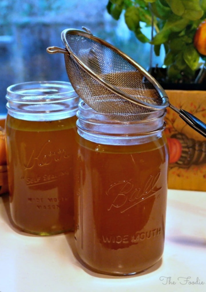 Homemade turkey stock in clear mason jars. 