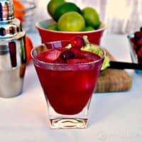 Cranberry Cosmopolitan in a clear glass with lime