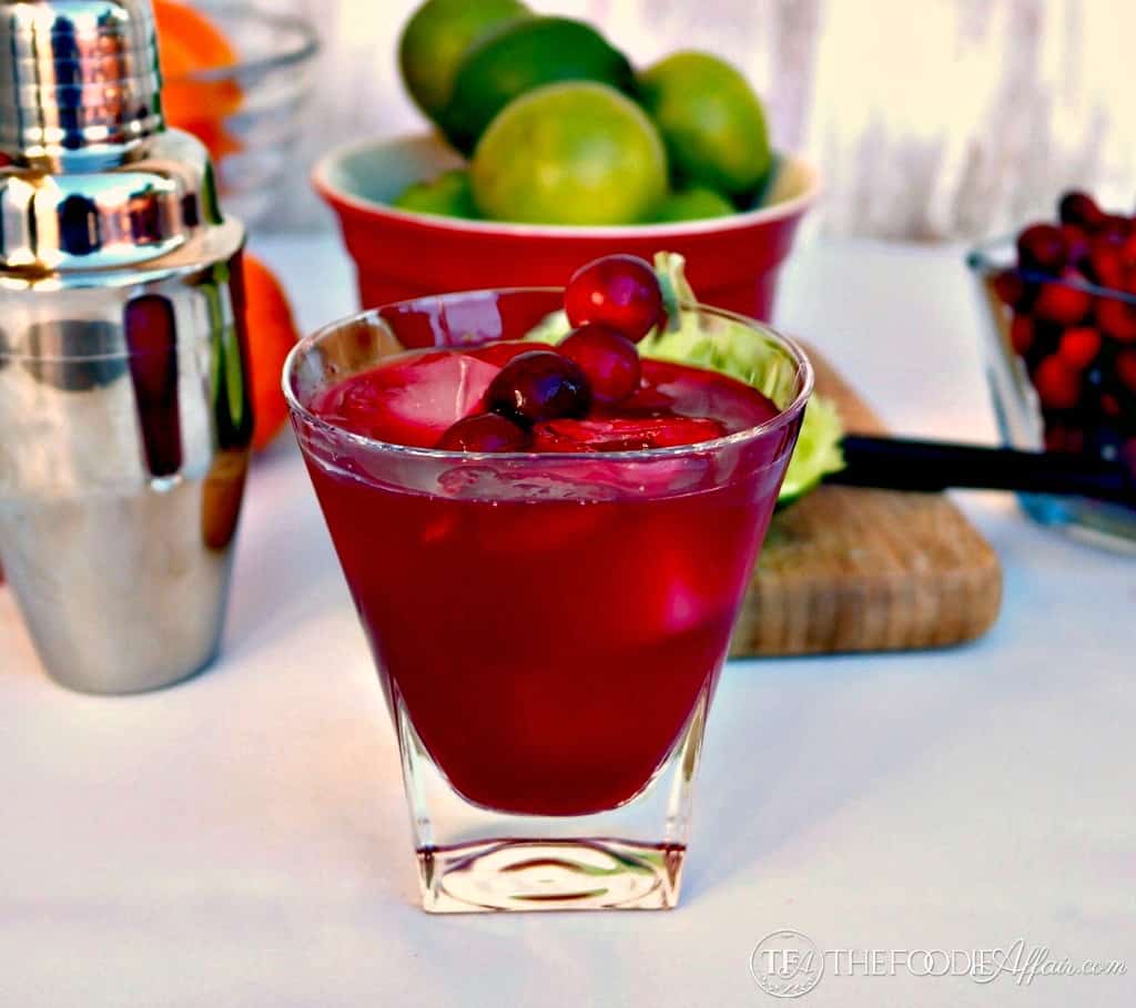 Cranberry Cosmopolitan in a clear glass with lime