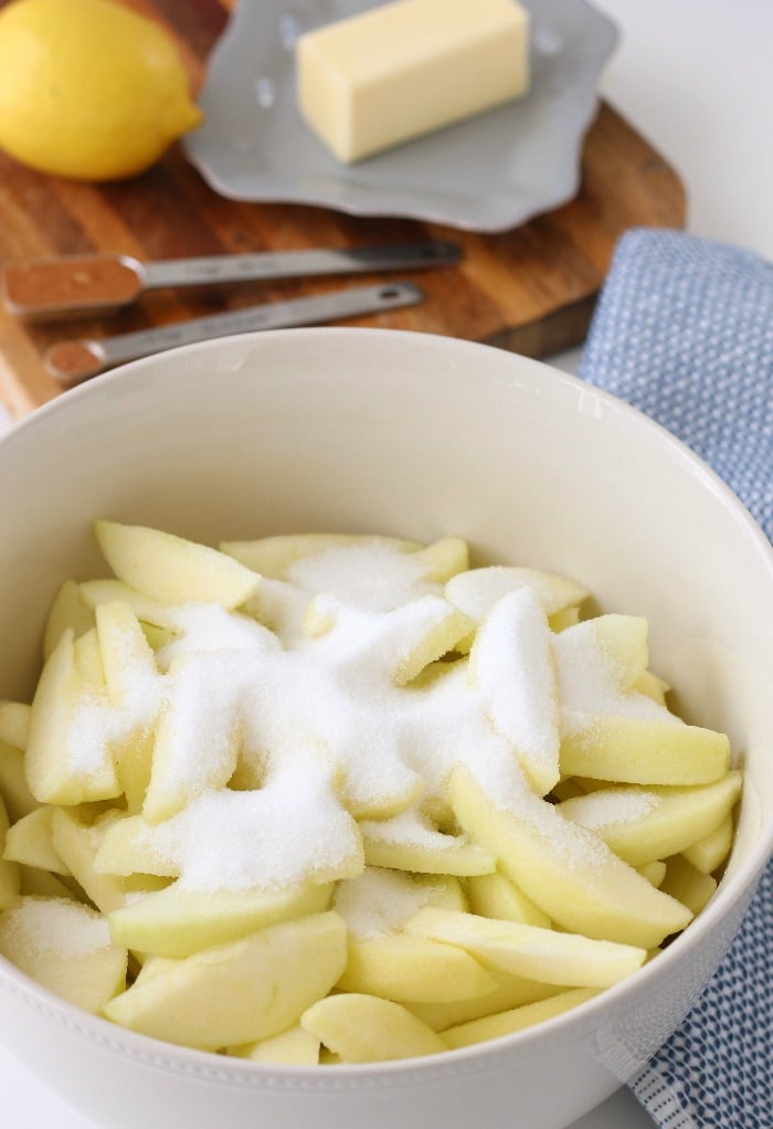 Sugar being added to the apple pie filling to freeze. I'll show you how to freeze apple pie!