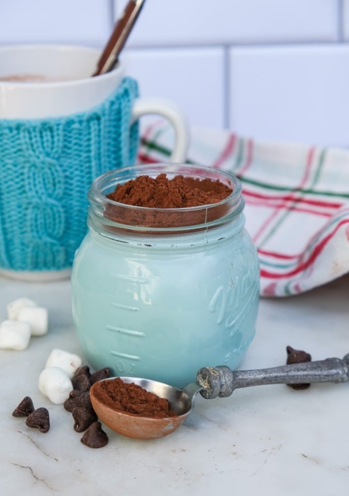 Homemade hot cocoa in a teal mason jar.