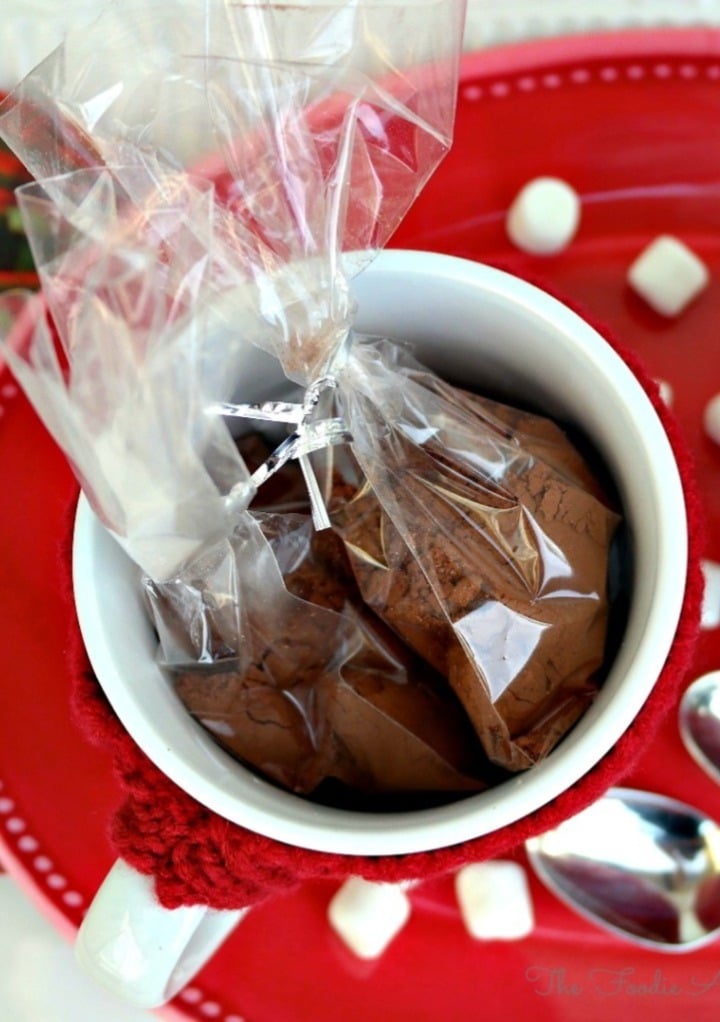 Hot cocoa mix wrapped in cellophane and tucked in a white mug.  