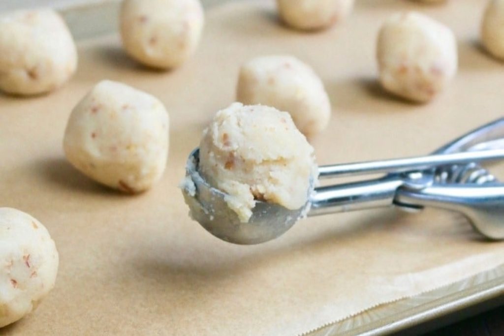 Mexican cookie dough on a baking sheet before baking.