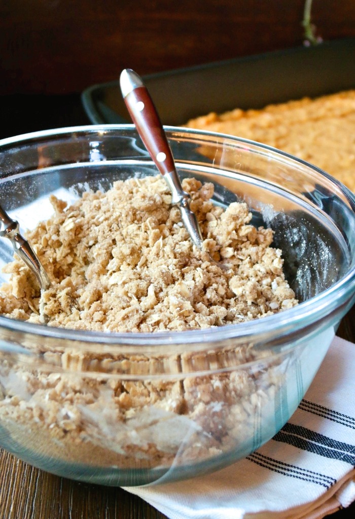 coffee cake crumble mixed in a clear mixing bowl
