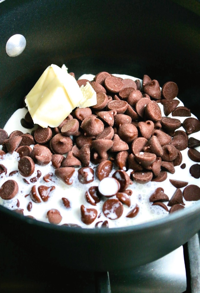 Chocolate, butter and cream in a sauce pan ready to be melted to make truffles