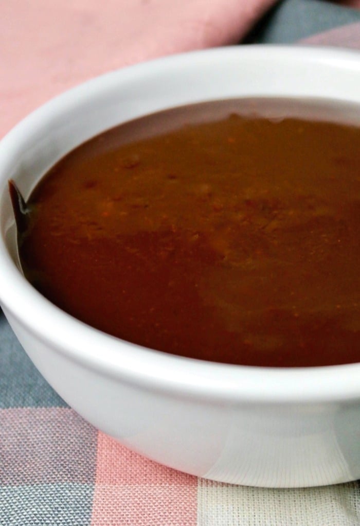 Chocolate ganache for truffles is cooling in a white small bowl