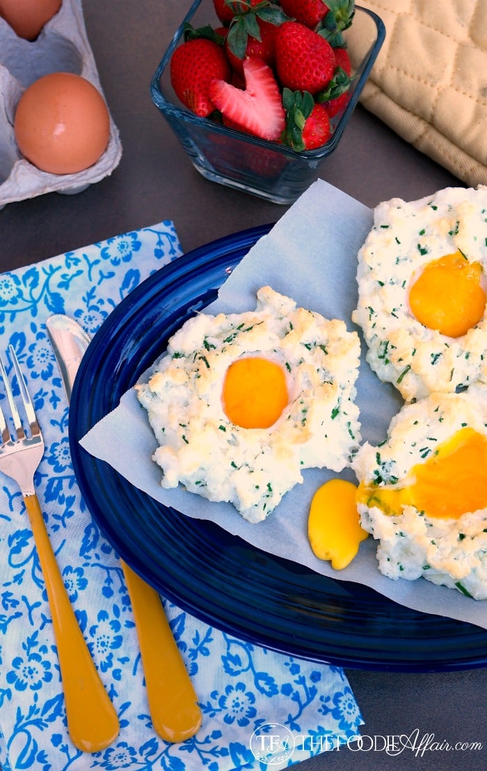 Light and fluffy whipped egg whites with the yolk in the center on a blue platter