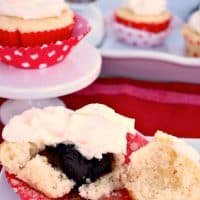 Fudge Filled Vanilla Cupcakes in a red baking cupcake liner
