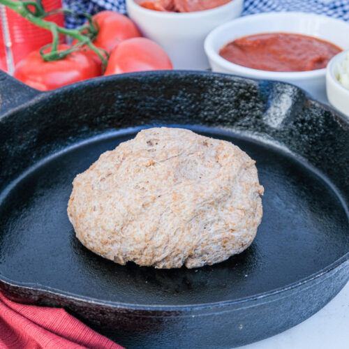 whole wheat pizza dough on a iron skillet.