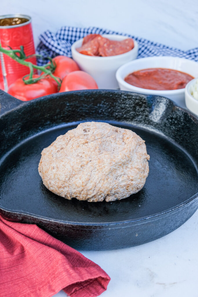 whole wheat pizza dough on a iron skillet.