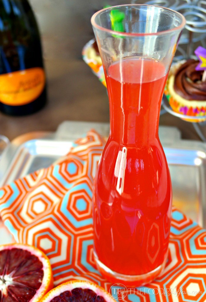 Blood Orange for French 75 recipe in a clear decanter