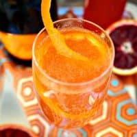 Blood Orange French 75 in a fluted glass