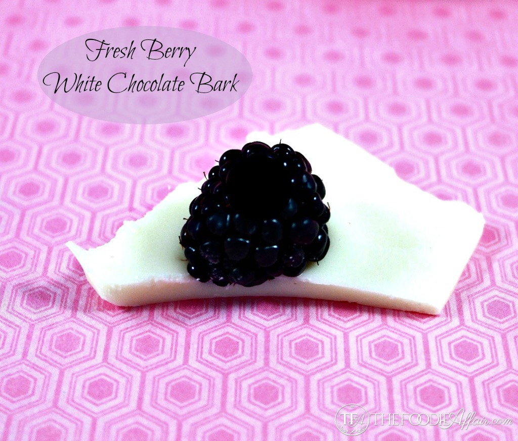 A piece of White Chocolate Bark topped with a blackberry