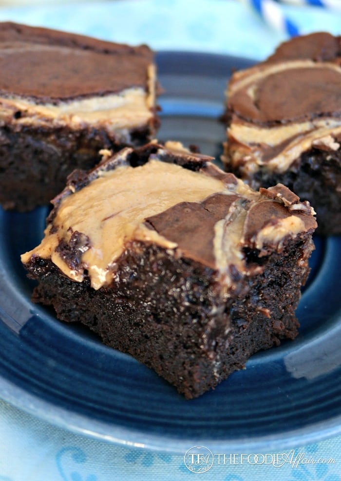 Peanut Butter Brownies with gooey peanut butter dripping onto a blue plate