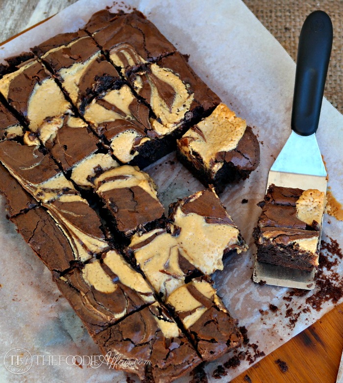 Peanut Butter Brownies cut in squares on a white piece of parchment paper