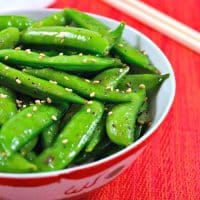 Sugar snap peas in a white and red bowl