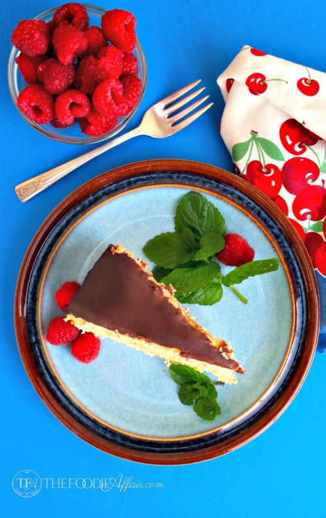 Best Boston cream pie on a blue plate with red raspberries