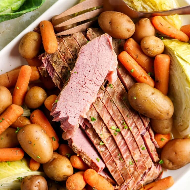corned beef meal with cabbage and carrots on a platter.