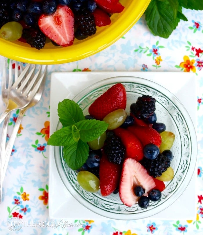 fruit salad in a clear bowl on a white plate