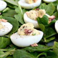 Smoked Salmon Deviled Eggs over a bed of fresh green spinach