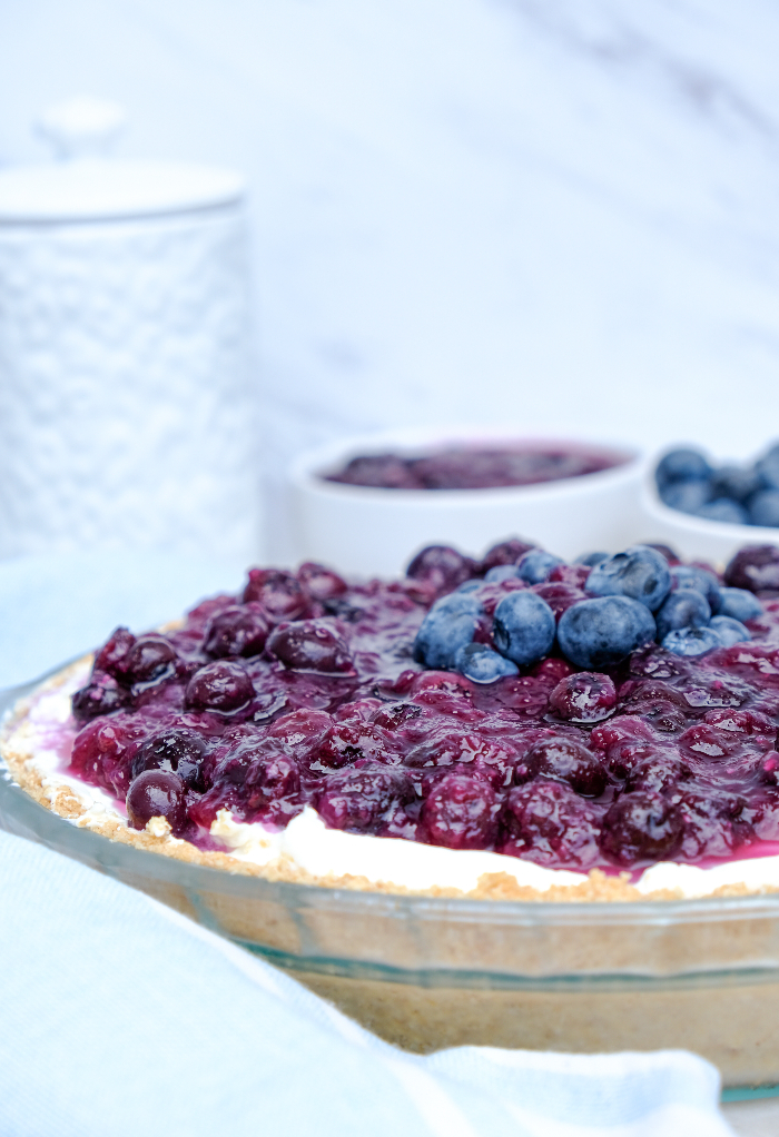 Homemade no bake blueberry cream cheese pie in a clear baking dish.