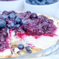 A slice removed from a no bake blueberry cream cheese pie.