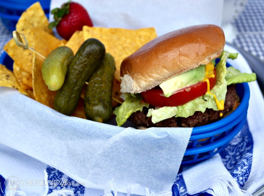 grilled hamburgers with a side of chips