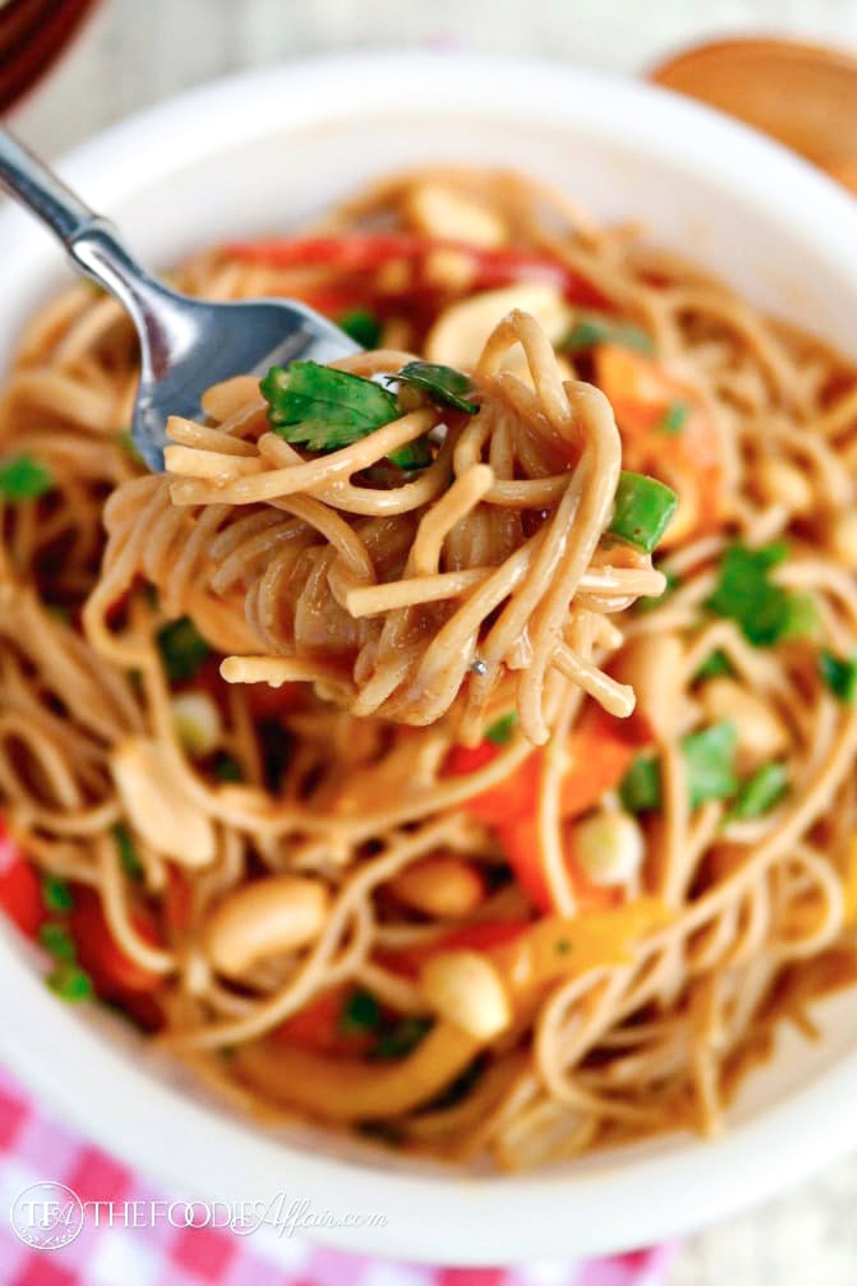 A white bowl of noddles ready to be served. 