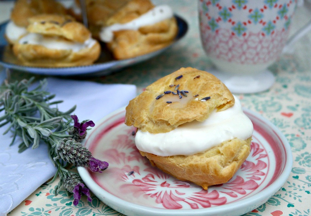 Lavender Cream Puffs filled with whipped cream and topped with a lavender glaze - The Foodie Affair