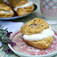 Lavender Cream Puffs filled with whipped cream and topped with a lavender glaze - The Foodie Affair