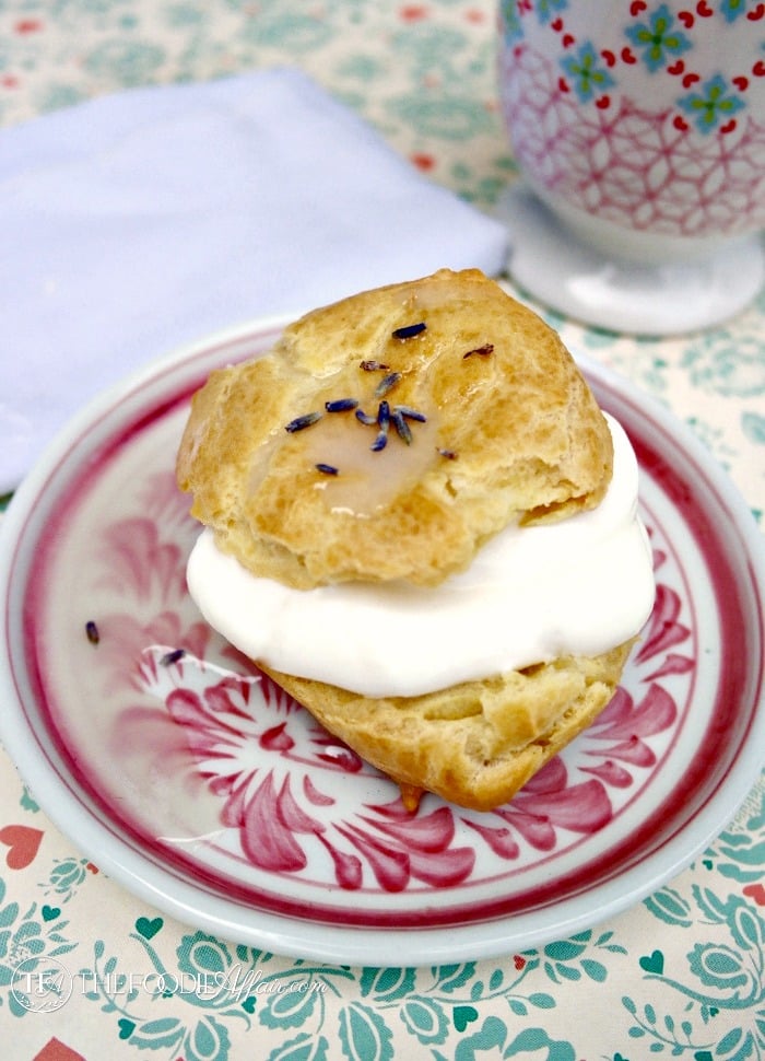 Lavender Cream Puffs filled with whipped cream and a lavender glaze - The Foodie Affair