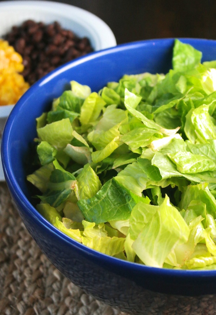 Bite size lettuce in a blue bowl 