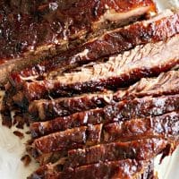 oven cooked brisket on a white serving plate