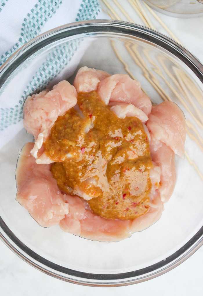 Prepared marinade over chicken tenderloins.