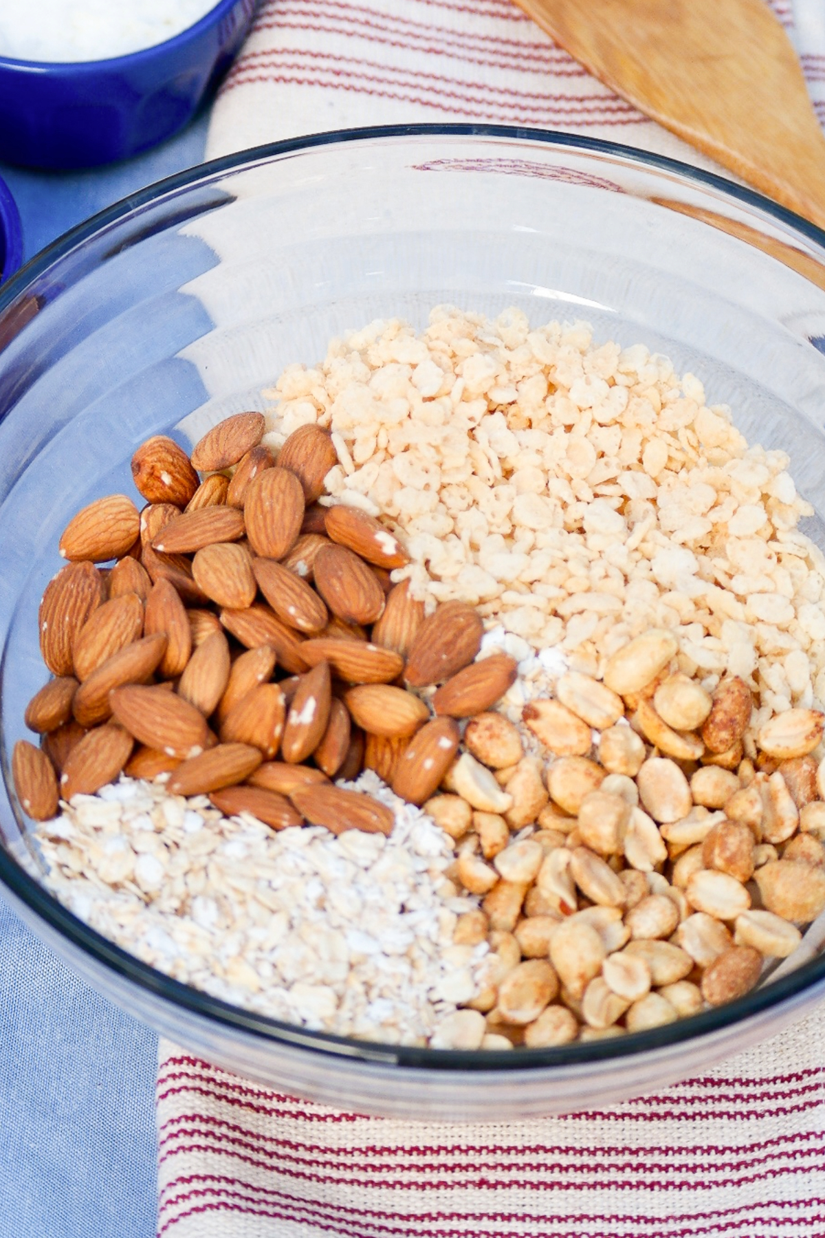 Ingredients in a clear mixing bowl for granola bars. 