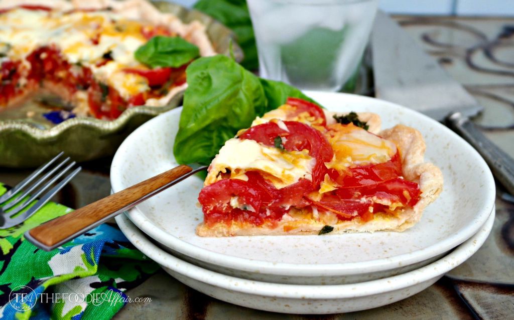 Fresh savory tomato pie topped with cheese, garlic and basil - The Foodie Affair